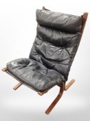 A 20th century Danish bentwood and black button leather lounge chair,