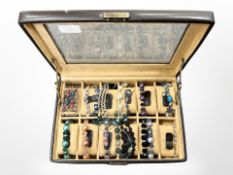 A modern watch display box containing costume bracelets