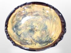 A slip-glazed earthenware bowl, diameter 38cm.