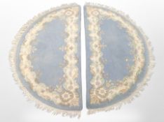A pair of Chinese demi-lune rugs,
