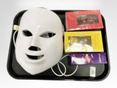 A Gwen Stefani LED light mask with remote control, together with three bottles of perfume.