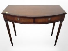 A reproduction mahogany bow fronted hall table,