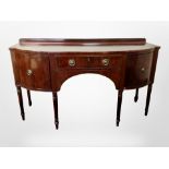 A 19th century mahogany bow-front buffet sideboard in the George III style,