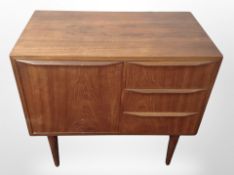 A Danish teak low chest fitted three drawers and falling cabinet,