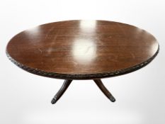 A reproduction mahogany oval coffee table,