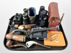 A group of antique and modern binoculars, pipes, Nettar camera, etc.