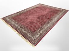 A machine made carpet of Persian design,