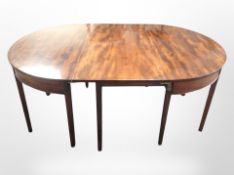 A George III mahogany extending dining table, with leaf,