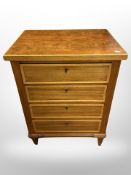 A walnut and satin wood banded four drawer chest,