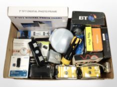 A box containing home electricals including digital photo frame, underwater cameras, MP3 player,