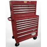An enameled metal mechanic's storage trolley, with multiple drawers containing some tools.