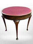 A mahogany turnover top games table on cabriole legs, with baise lined interior,