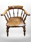 A 19th century elm captain's style chair,
