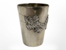 A small Chinese silver beaker depicting a four-clawed dragon, height 3.