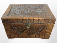 A small oriental carved camphor wood chest, width 40cm.