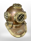 A reproduction copper and brass US Navy diving helmet.
