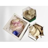 Three hat boxes containing assorted lady's dress hats.