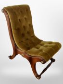 A reproduction scroll framed chair in buttoned olive upholstery