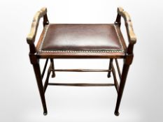A Victorian mahogany piano stool with studded brown leather seat pad,