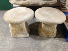 A pair of concrete staddle stones, height 42cm.