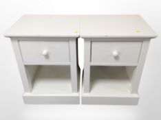 A pair of contemporary white bedside chests,