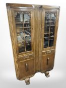 A 1930s carved oak double-door bookcase, 91cm wide x 32cm deep x 152cm high.