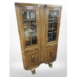 A 1930s carved oak double-door bookcase, 91cm wide x 32cm deep x 152cm high.