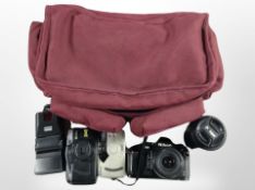 A camera bag containing Nikon F-501 camera with AF Nikkor 35-80mm lens, further 70-300mm lens,