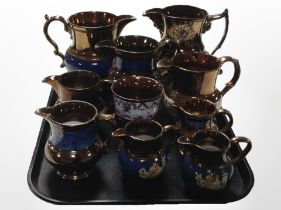 A collection of Victorian copper lustre jugs.