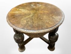 A carved oak circular coffee table on bulbous legs, 80cm diameter, 55cm high.