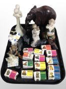 A group of boxed Wade Whimsies, wood and stone carvings, Willow Tree figurines, etc.