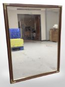 A brass-mounted mirror, 110cm x 85cm.