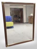 A brass-mounted mirror, 110cm x 85cm.