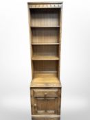 An Ercol elm open bookcase, 52cm wide x 49cm deep x 196cm high.