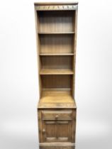 An Ercol elm open bookcase, 52cm wide x 49cm deep x 196cm high.