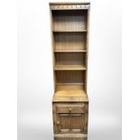 An Ercol elm open bookcase, 52cm wide x 49cm deep x 196cm high.