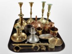 A group of brass candlesticks and chamber sticks, pewter example, brass weights, copper funnel, etc.