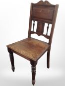 A Victorian oak hall chair.