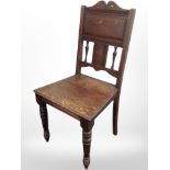 A Victorian oak hall chair.