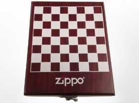 A Zippo miniature chess set in fitted box containing a further Zippo lighter, hip flask,