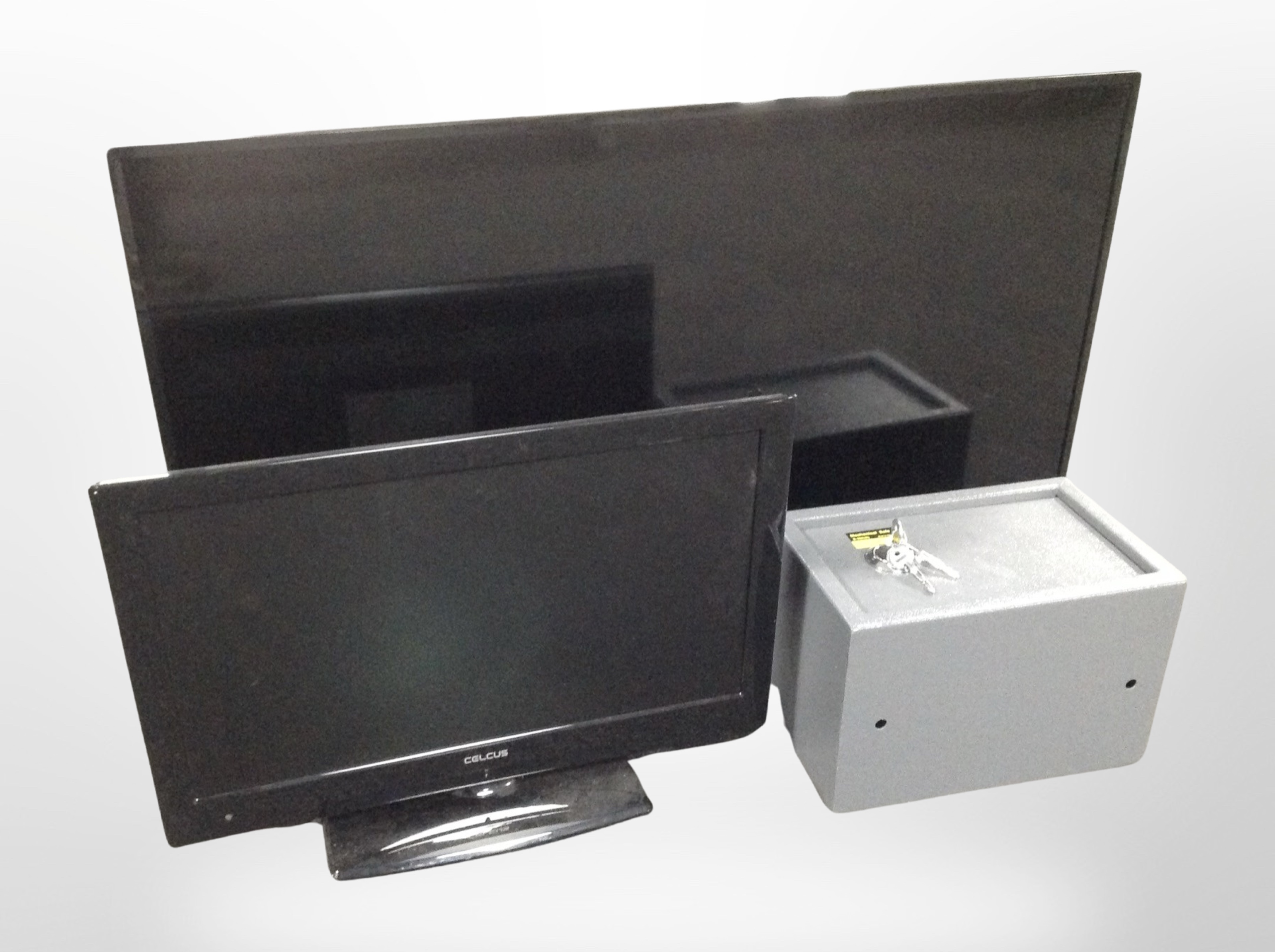 A Panasonic 40-inch LCD TV with remote, a further TV with remote, and a small safe with keys.