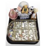 A brass and glass display stand containing assorted ceramic thimbles,