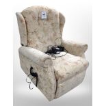 An electric reclining armchair in floral upholstery