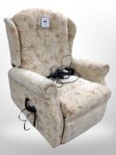 An electric reclining armchair in floral upholstery