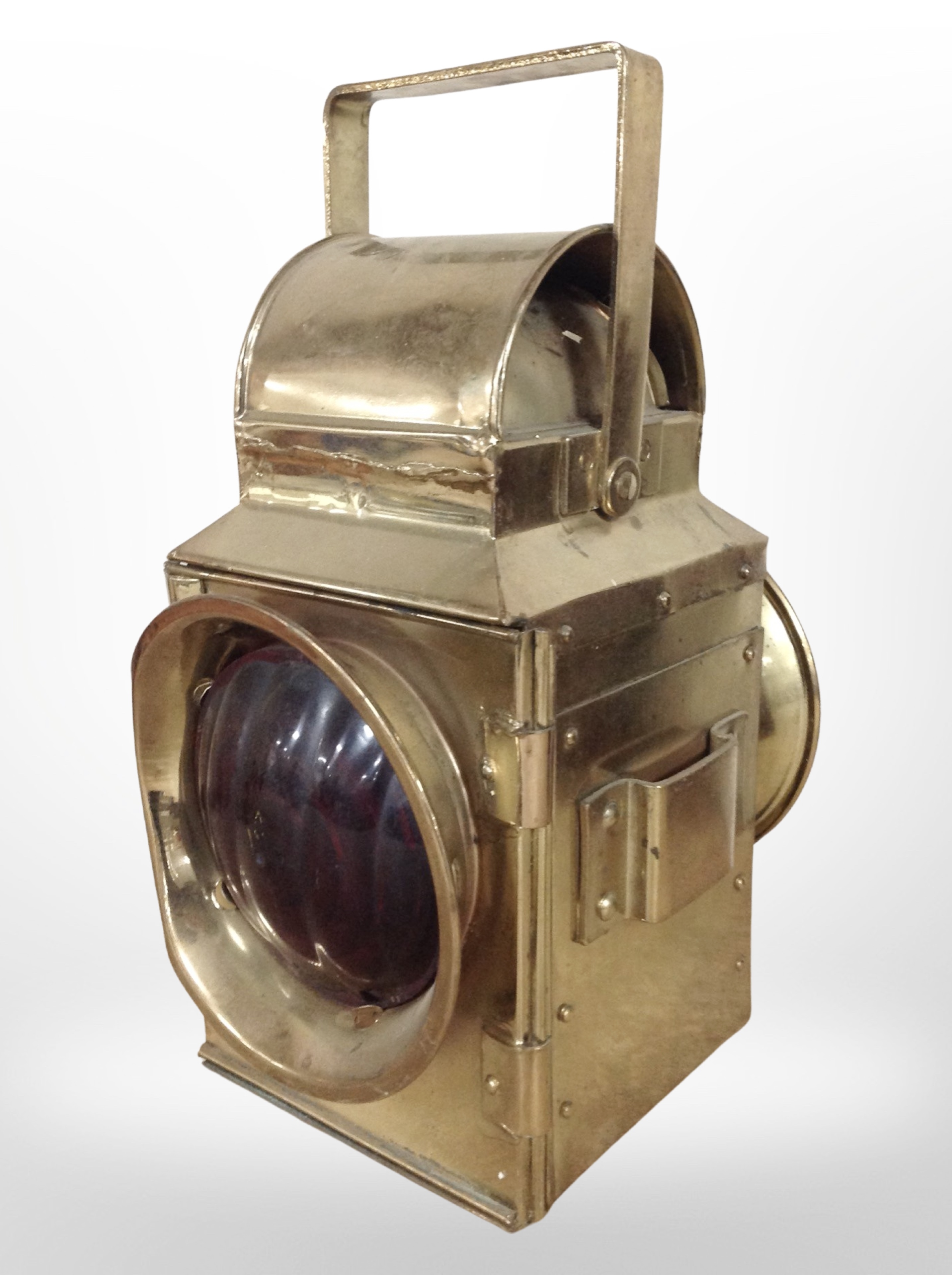 A brass railway lamp with red glass lenses (wired for electricity), height 37cm.