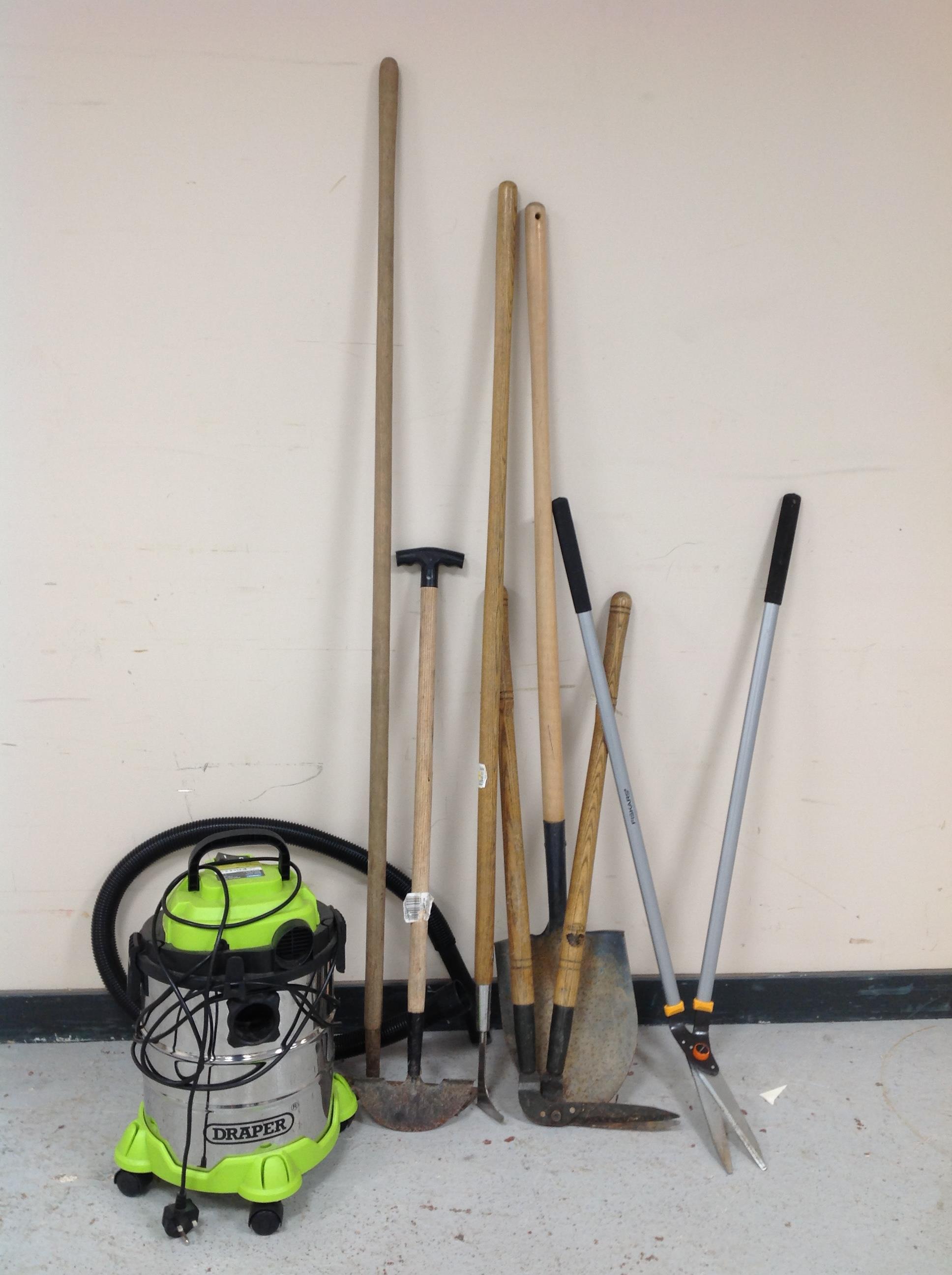 A Draper vacuum cleaner and a quantity of garden tools.