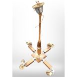 A mid-20th century walnut-veneered four-sconce pendant light fitting, height 70cm.