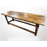 An 18th-century oak plank-top refectory dining table, 223cm long x 65cm wide x 77cm high.