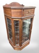 A reproduction mahogany cabinet with leaded glass doors, 56cm wide x 43cm deep x 107cm high.