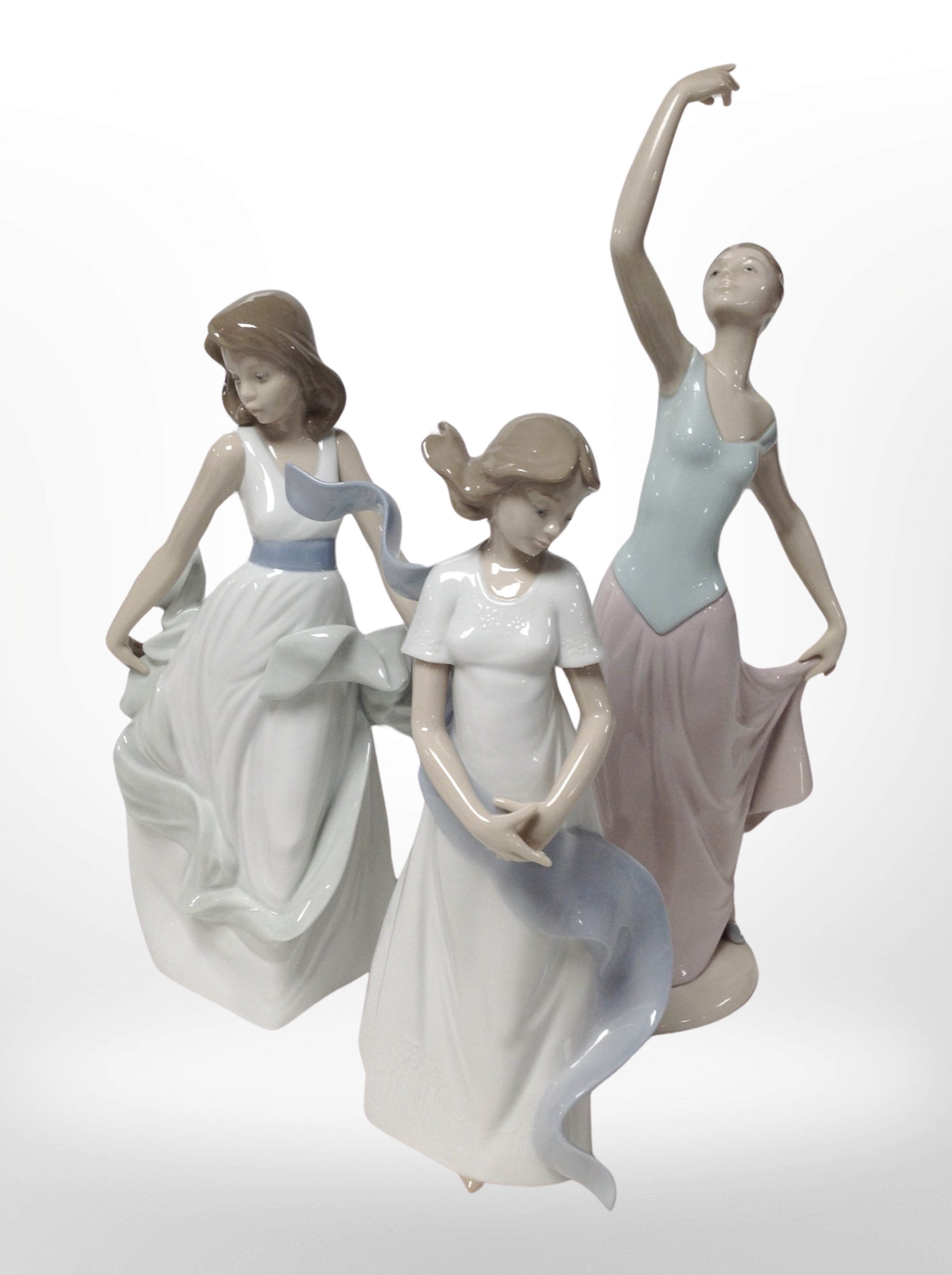 Three Nao figures of ladies, tallest 34cm.